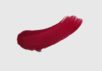 Cosmetic make-up beauty product. Matte burgundy claret maroon lipstick swatch isolated on light...
