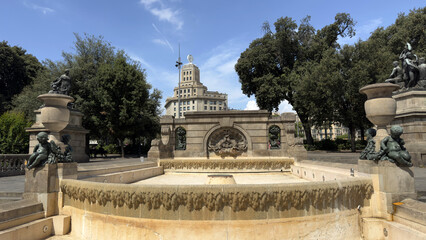 Historic Stone Fountain with Sculptures and Classical Architecture in Barcelona's Plaça de...