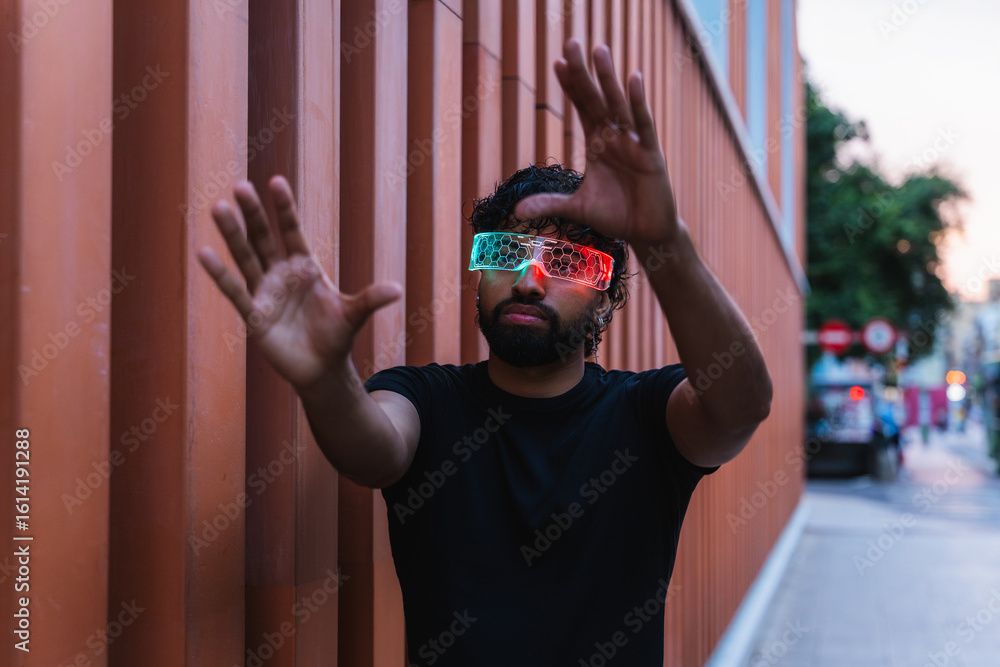 Poster young latin software developer using augmented reality glasses interacting with virtual interface in