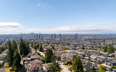 Aerial View of Burnaby Cityscape Surrounded by Suburban Houses and Lush Greenery