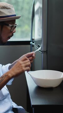 Young chef savoring a meal in a modern kitchen
