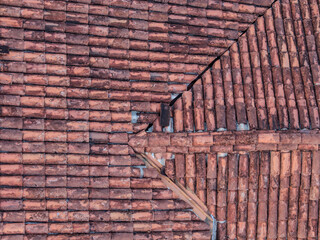 Aerial top-down views of traditional clay tile rooftops on colonial-style houses, showcasing warm...
