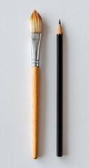 Artist's brush and pencil on white background.  Studio shot, tools, art supplies