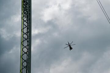 Rescue ladder of the Flensburg fire department with a Danish rescue helicopter at cloudy weather