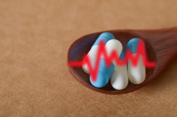 Wooden Spoon with Pills and Heartbeat Line Symbolizing Medical Treatment and Cardiovascular Health