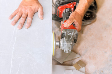 Craftsman polishing tile stone surface with power tool, showcasing expertise in workshop...
