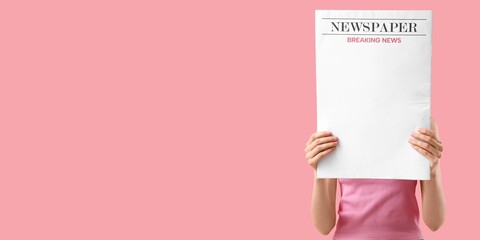 Woman holding newspaper on pink background with space for text