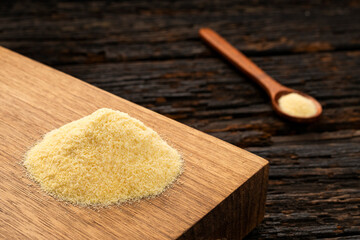 Wheat semolina in a wooden spoon - Triticum