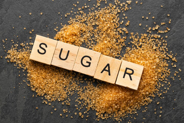 Saccharum officinarum - Brown granulated sugar scattered on the table