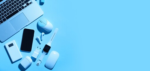 Set of modern devices and gadgets on blue background with space for text