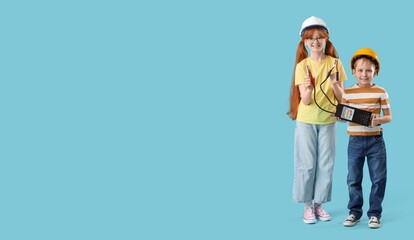 Cute inventors with battery tester on blue background with space for text