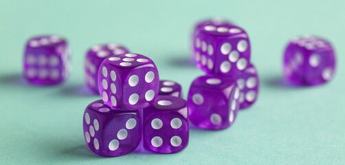 Many dices on turquoise background, closeup