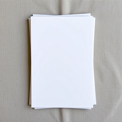 Blank sheets of paper stacked on a textured surface, ready for writing, crafting, or printing purposes