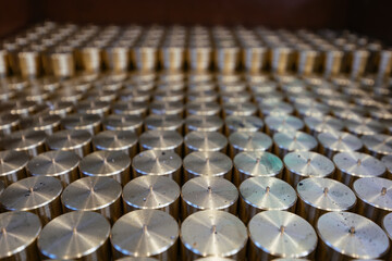 Cylindrical spare parts in rows, close up