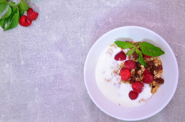 Healthy breakfast. Granola with pumpkin seeds, honey, yogurt and fresh berries in a ceramic bowl on...
