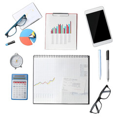 Flat lay of office supplies, charts, and graphs.  A collection of business tools, including tablet, clipboard, notepad, pens, glasses, calculator, and timer