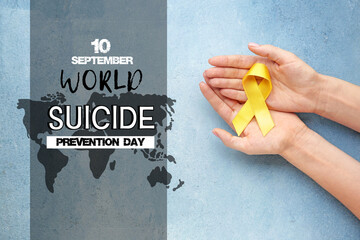 Female hands with yellow ribbon on color background. Cancer awareness concept