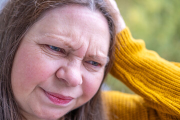 mature woman experiencing hot flashes due to menopause and high blood pressure, high blood...