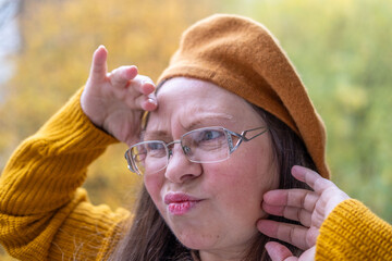 Playful woman making funny face, funny freak portrait with playful gestures, whimsical expression, Spontaneous moment captured outdoors