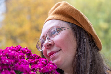 flower gift, Autumn's gentle embrace, woman's serene moment with aster blooms, essence of fall,...