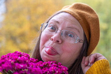 flower gift, Autumn's gentle embrace, woman's serene moment with aster blooms, essence of fall,...