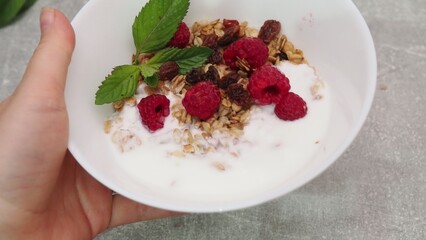 bowl with Greek yogurt homemade granola, mixed nuts, almond, cashew, hazelnut. Healthy vegetarian protein diet breakfast. Selective focus, closeup