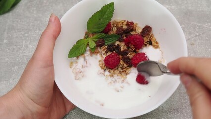bowl with Greek yogurt homemade granola, mixed nuts, almond, cashew, hazelnut. Healthy vegetarian protein diet breakfast. Selective focus, closeup