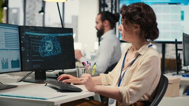 Woman employee using AI machine learning for efficiency recognition, using a synergy of data sharing and optimization models in a co working space. IT company artificial intelligence. Camera B.