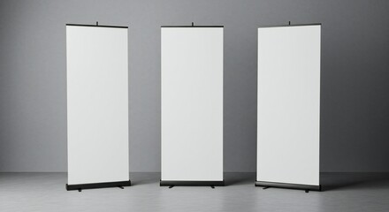 Three white roll-up banners against a gray background, minimalist style, natural lighting, symmetrical composition.
