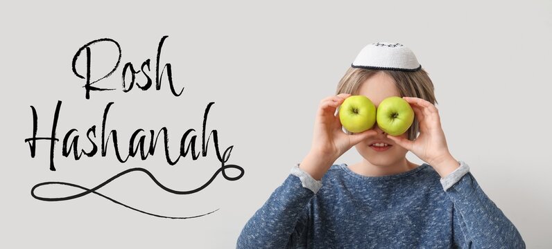 Little boy with apples on grey background. Banner for Rosh Hashanah (Jewish New Year) celebration - Powered by Adobe