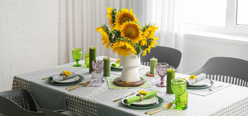 Served table with sunflowers in dining room