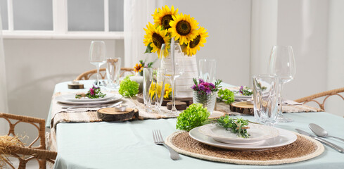 Served dining table with beautiful sunflowers and floral decor