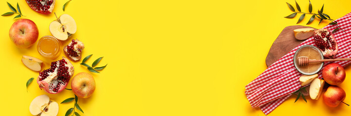 Composition with bowl of honey and fruits on yellow background. Rosh hashanah (Jewish New Year)...