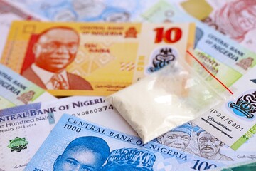 Nigerian naira currency money bills and cocaine pack. The concept of drug trafficking