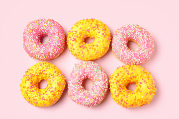 Sweet donuts on pink background