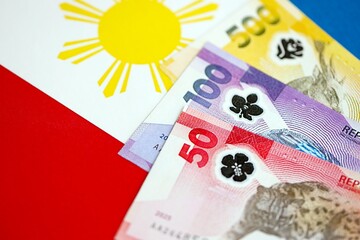 Philippines peso currency money bills lies on flag. The concept of business and investment