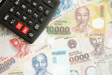 Vietnamese dong currency money bills and calculator. The concept of taxation and money count