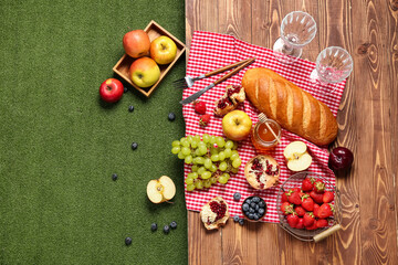 Composition with tasty food for picnic and glasses on wooden table outside