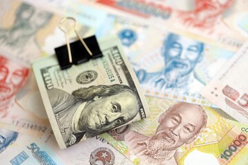 Vietnamese dong currency money bills and bunch of us dollar banknotes. The concept of economics and...