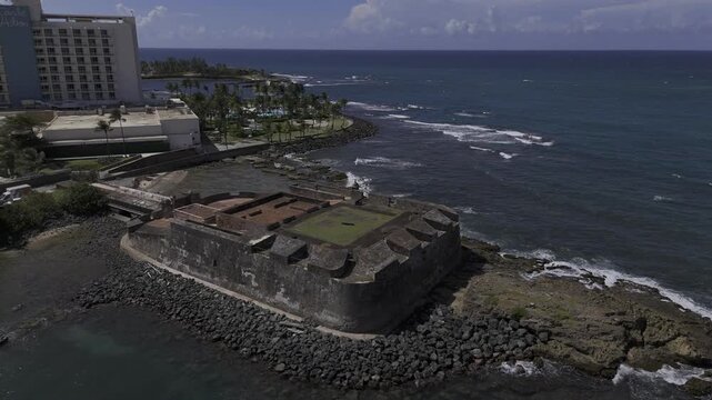 Drone does 360 around Fortin de San Jeronimo del Boqueron on sunny morning in San Juan, Puerto Rico