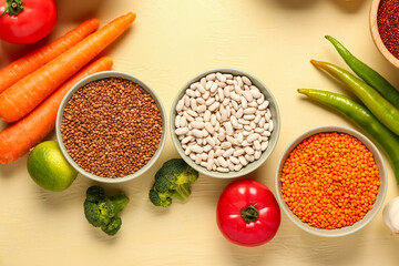 Different fresh vegetables and cereals on yellow background, closeup