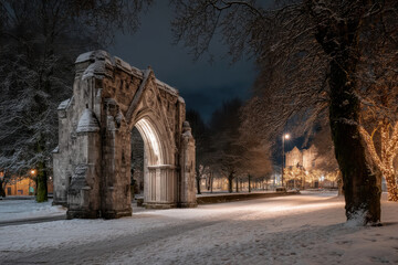 enchanting winter scene featuring ancient church gates blanketed in snow