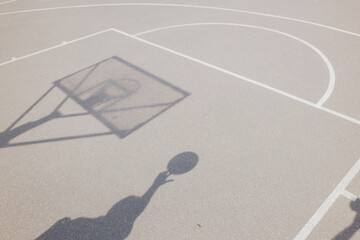 Basketball action at a vibrant court with dynamic shadows
