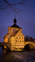 Fototapeta premium Historic bamberg town hall on river at twilight with bridge