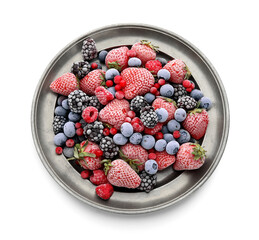 Plate with frozen berries on white background