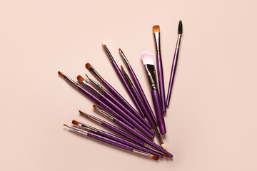 Makeup brushes on pink background