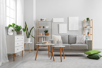 Grey sofa with cushions in interior of modern living room
