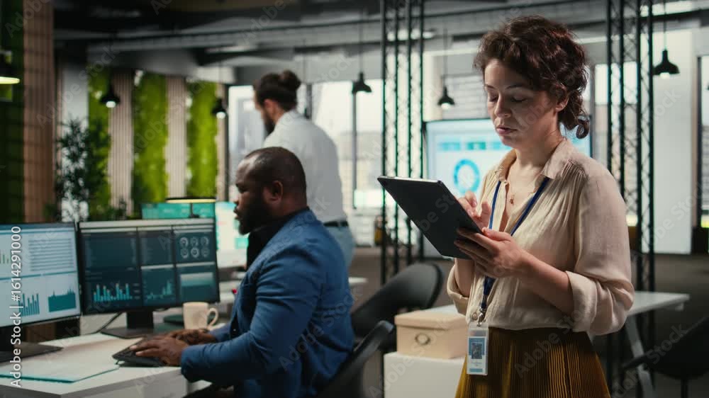 Poster pensive woman business leader does forecasting on her tablet in the office, working in a multination