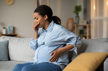 Pregnancy Morning Sickness. Pregnant Black Lady Suffering From Nausea Holding Hand Near Mouth...