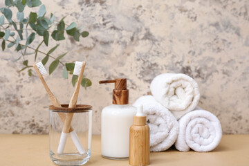 Set of bath supplies with bamboo toothbrushes on grunge background